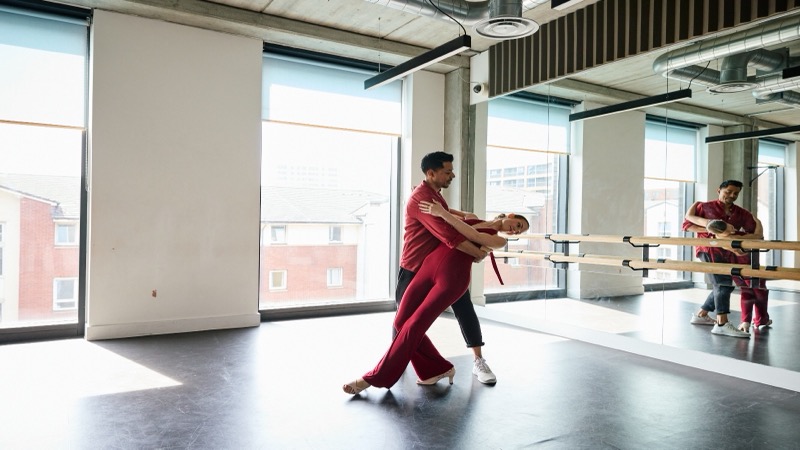 Dance couple in a boutique studio with mirrors